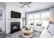 Inviting living room with fireplace, comfortable seating, and a ceiling fan for added comfort at 755 Bachelor Gulch Way, Apex, NC 27523
