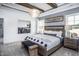 Comfortable main bedroom with decorative ceiling beams and a chandelier at 755 Bachelor Gulch Way, Apex, NC 27523