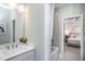 Well-lit bathroom featuring a vanity with a quartz countertop and modern fixtures at 756 Bachelor Gulch Way, Apex, NC 27523
