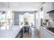 Open concept dining area features a modern light fixture and views of the backyard at 756 Bachelor Gulch Way, Apex, NC 27523