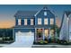 Charming two-story home features a blue exterior, a two-car garage, and a welcoming front porch at 756 Bachelor Gulch Way, Apex, NC 27523