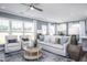 Bright living room with large windows, neutral furniture, and stylish decor at 756 Bachelor Gulch Way, Apex, NC 27523