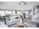 Open-concept living area with modern decor, a fireplace, and adjacent kitchen at 756 Bachelor Gulch Way, Apex, NC 27523