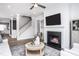 Living room with fireplace, television, and access to the upstairs at 756 Bachelor Gulch Way, Apex, NC 27523