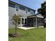 Lovely backyard with a screened porch and a concrete patio area with lush green grass at 760 Bachelor Gulch Way, Apex, NC 27523