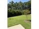 Expansive backyard featuring lush green grass and mature trees providing privacy at 760 Bachelor Gulch Way, Apex, NC 27523