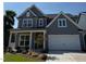 Charming two-story home with a two car garage and a welcoming front porch and well manicured landscaping at 760 Bachelor Gulch Way, Apex, NC 27523