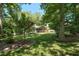 Beautiful backyard with a lush lawn, mature trees, and a screened-in porch for outdoor enjoyment at 9 Kimberly Dr, Durham, NC 27707