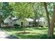 Charming single-story home with a meticulously landscaped front yard and mature trees at 9 Kimberly Dr, Durham, NC 27707