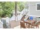 Inviting back deck with a wooden dining table, rocking chairs, and stairs leading to the backyard at 918 Orient St, Durham, NC 27701
