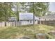 View of fenced backyard with gardening beds and shade trees at 918 Orient St, Durham, NC 27701