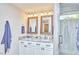 A bathroom with double sink vanity, decorative mirrors, and modern fixtures at 918 Orient St, Durham, NC 27701