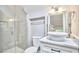 Bathroom featuring tiled shower and vanity with vessel sink at 918 Orient St, Durham, NC 27701