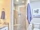 Modern bathroom with a glass-enclosed shower and neutral colored tiling at 918 Orient St, Durham, NC 27701