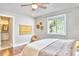A sunlit bedroom features hardwood floors, and a view to the outside at 918 Orient St, Durham, NC 27701