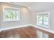 Bright bedroom features hardwood floors and large windows at 918 Orient St, Durham, NC 27701