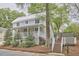 Charming two-story home with a metal roof, inviting front porch, and well-manicured landscaping at 918 Orient St, Durham, NC 27701
