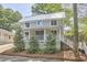 Charming two-story home with a metal roof, inviting front porch, and well-manicured landscaping at 918 Orient St, Durham, NC 27701