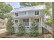 Charming two-story home with a metal roof, inviting front porch, and well-manicured landscaping at 918 Orient St, Durham, NC 27701