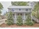 Charming two-story home boasts a welcoming front porch and metal roof at 918 Orient St, Durham, NC 27701