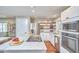 Eat in kitchen with stainless appliances, center island, open floor plan, and view into the living room at 918 Orient St, Durham, NC 27701