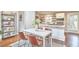 Eat in kitchen with modern dining table, stainless appliances, and open shelving perfect for dining and entertaining at 918 Orient St, Durham, NC 27701