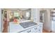 Well-lit kitchen with stainless appliances, white subway tile, and open shelving is perfect for cooking and entertaining at 918 Orient St, Durham, NC 27701
