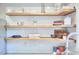 Bright kitchen featuring white cabinets, subway tile backsplash and floating wood shelves at 918 Orient St, Durham, NC 27701