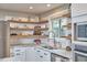 Bright kitchen with stainless appliances, a large island, and view to the living room is perfect for cooking and entertaining at 918 Orient St, Durham, NC 27701