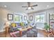 Bright living room featuring hardwood floors, large windows, and stylish furniture at 918 Orient St, Durham, NC 27701