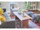 Living room with tufted sofa, natural wood table, and colorful rug exudes a stylish and inviting ambiance at 918 Orient St, Durham, NC 27701