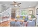 Charming living room with hardwood floors, a ceiling fan, and stairs at 918 Orient St, Durham, NC 27701