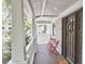 Inviting front porch with outdoor seating, views of the neighborhood, and beautiful dark wood door at 918 Orient St, Durham, NC 27701