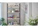Stylish shelving unit with books, plants and decorative accents adds charm and character to the space at 918 Orient St, Durham, NC 27701