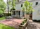 Backyard with patio, dining set, screened-in porch and flower bed; perfect for outdoor living at 1002 Springmill Ct, Apex, NC 27502