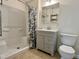 Bathroom featuring neutral-toned walls, a tub with shower, and vanity with storage at 1002 Springmill Ct, Apex, NC 27502