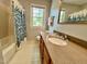 Bathroom with tub/shower combination, granite countertop, updated vanity, and bright natural light at 1002 Springmill Ct, Apex, NC 27502