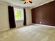 Bedroom featuring plush carpeting, ceiling fan, bay window with dark curtains, and fresh paint at 1002 Springmill Ct, Apex, NC 27502