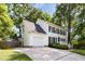 Two-story home with white siding, black shutters, attached garage, and spacious driveway at 1002 Springmill Ct, Apex, NC 27502