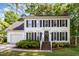 Traditional two-story home with white siding, black shutters, and a well-manicured front yard at 1002 Springmill Ct, Apex, NC 27502