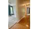 Hallway view of room featuring natural light, wood floors, and a closet with louvered doors at 1002 Springmill Ct, Apex, NC 27502