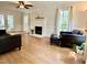 Bright living room featuring hardwood floors, fireplace, neutral walls, and large windows with natural light at 1002 Springmill Ct, Apex, NC 27502