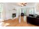 Bright living room featuring hardwood floors, fireplace, neutral walls, and large windows with natural light at 1002 Springmill Ct, Apex, NC 27502