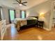 Spacious main bedroom featuring natural light, hardwood floors, and neutral-colored walls at 1002 Springmill Ct, Apex, NC 27502