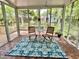 Cozy sunroom with tiled floor, surrounded by large windows with a view of the lush backyard at 1002 Springmill Ct, Apex, NC 27502