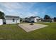 Expansive backyard with a concrete patio and a fire pit, perfect for outdoor gatherings and relaxation at 101 Pine St, Dunn, NC 28334