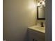 Compact bathroom showcasing a vanity with modern black hardware and a decorative light fixture above the mirror at 101 Pine St, Dunn, NC 28334