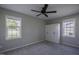 Bedroom featuring neutral walls, carpet flooring, built-in storage, and bright windows, providing a cozy atmosphere at 101 Pine St, Dunn, NC 28334