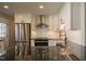 A modern kitchen featuring stainless steel appliances, black countertops, and a center island at 101 Pine St, Dunn, NC 28334