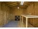 Functional shed interior featuring plywood walls, a worktable, shelving, and lighting, ready for various projects at 101 Pine St, Dunn, NC 28334